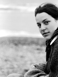A Young Woman Sitting Near the Sea Wearing a Thick Jumper Photographic Print by Leonora Saunders