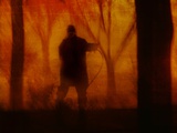 A Man Wearing a Long Coat Standing in the Woods Photographic Print by Susan Bein
