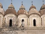 Woman with Broom Emerging from One of 108 Shiva Temples, Kalna, West Bengal, India Photographic Print by Annie Owen