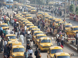 Yellow Kolkata Taxis and Commuters at Howrah Railway Station, Howrah, Kolkata (Calcutta), India Photographic Print by Annie Owen