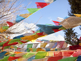 Prayer Flags Flying in Wind at Guishan Gongyuan Temple, Shangri-La (Zhongdian), China Photographic Print by Lynn Gail