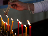 Person Lighting Incense Sticks in Prayer at Wat Mongkhon Nimit, Phuket Old Town, Phuket, Thailand Photographic Print by Lynn Gail