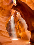 Sunlight Streams Through Cracks in a Slot Canyon Photographic Print by Mike Theiss