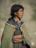 A Nomad Woman Tends to Her Sheep and Goats Photographic Print by Alex Treadway