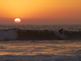Surfer Riding a Wave at Sunset over the Pacific Ocean Photographic Print by Tim Laman