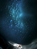 A Microbiologist Underneath the Blue Dome of an Ice Cave Photographic Print by Carsten Peter