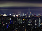 North Korea, Pyongyang, New Modern Buildings in the Centre of Pyongyang Colourfully Illuminated at  Photographic Print by Gavin Hellier