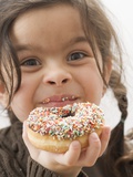 Girl Holding a Doughnut with Sprinkles, Partly Eaten Photographic Print