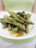 Woman Holding a Plate of Grilled Green Asparagus Photographic Print