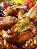 Brushing Pork Chop on Barbecue Rack with Oil Photographic Print by Paul Williams