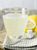 Hot Lemon with Sugar Cubes, Lemons in Background Fotografie-Druck von Kai Schwabe