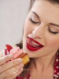A Girl Eating a Strawberry Muffin Photographic Print
