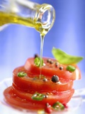 Spiced Tomatoes Being Drizzled with Olive Oil Photographic Print by Jean-Paul Chassenet