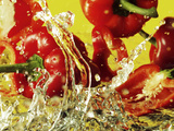 Peppers Falling into Water Against Yellow Background Photographic Print by Michael Meisen