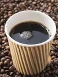 Black Coffee in Paper Cup on Coffee Beans Photographic Print