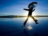 A Young Woman Running and Jumping on a Salt Flats at Sunrise Photographic Print by Sergio Ballivian
