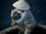 A Woman Paddles Her Round Basket Boat (Th Ng Chai) Through Halong Bay, Vietnam. Photographic Print by Randall Tate