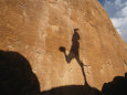 A Runners Shadow Falls on a Rock Lámina fotográfica por Dugald Bremner