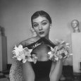 Model Wearing a Flowery Glove While Peering Into the Distance Photographie par Nina Leen