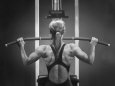 Rear View of a Woman Exercising on a Machine Lámina fotográfica