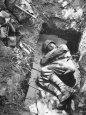 American Soldier of Mechanized Unit Sleeping in Foxhole Lined with Cardboard