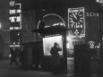 Man in a Raincoat Studies the Westminster City Guide Map at Night in Piccadilly Circus