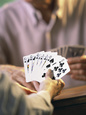 Man Holding Playing Cards