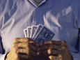 Mid Section View of a Man Holding Playing Cards