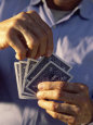 Mid Section View of a Man Holding Playing Cards
