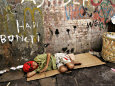 An Indonesian Boy Wearing a Spiderman Mask Sleeps on a Piece of Cardboard